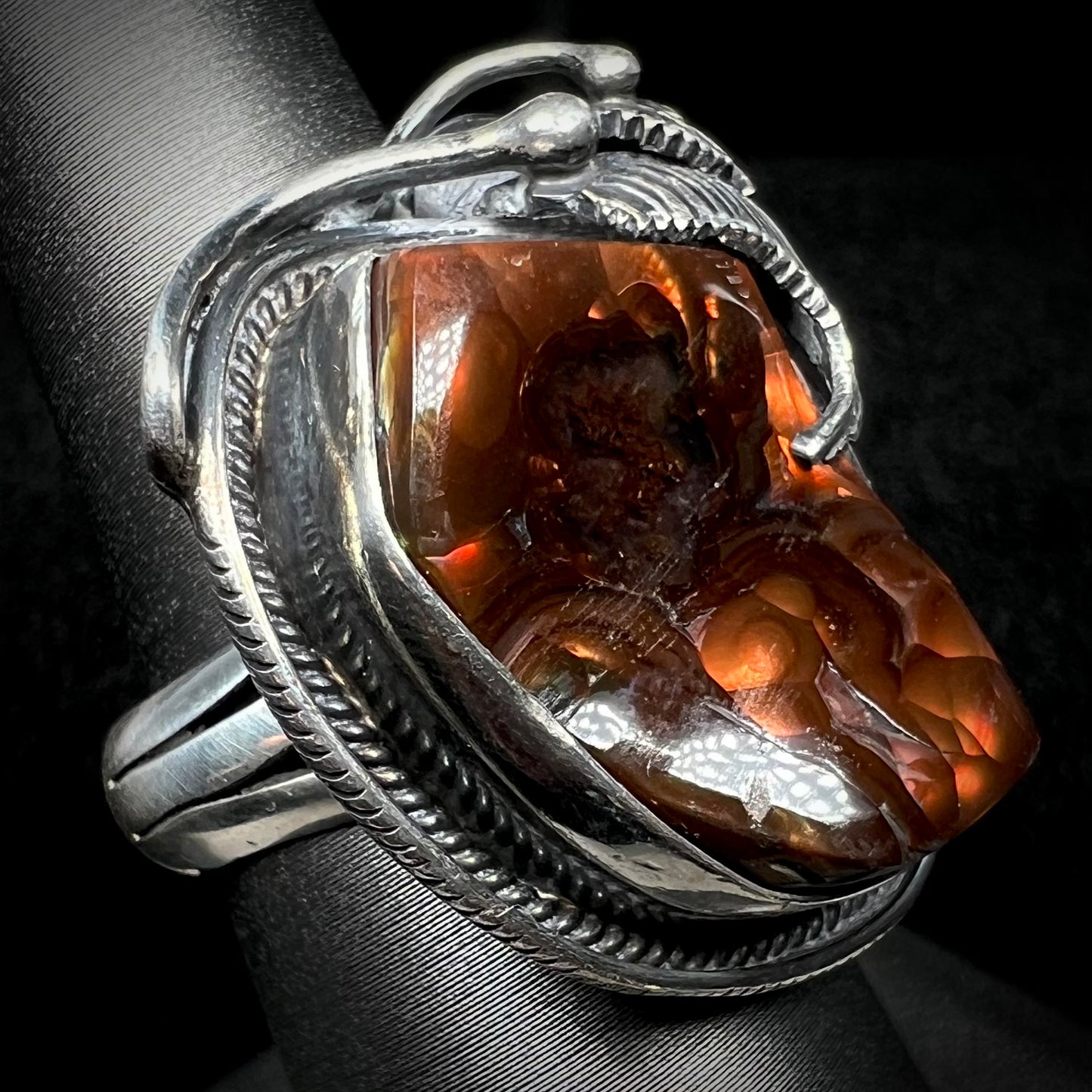 Angled view of a men's silver, Southwest-style fire agate ring.