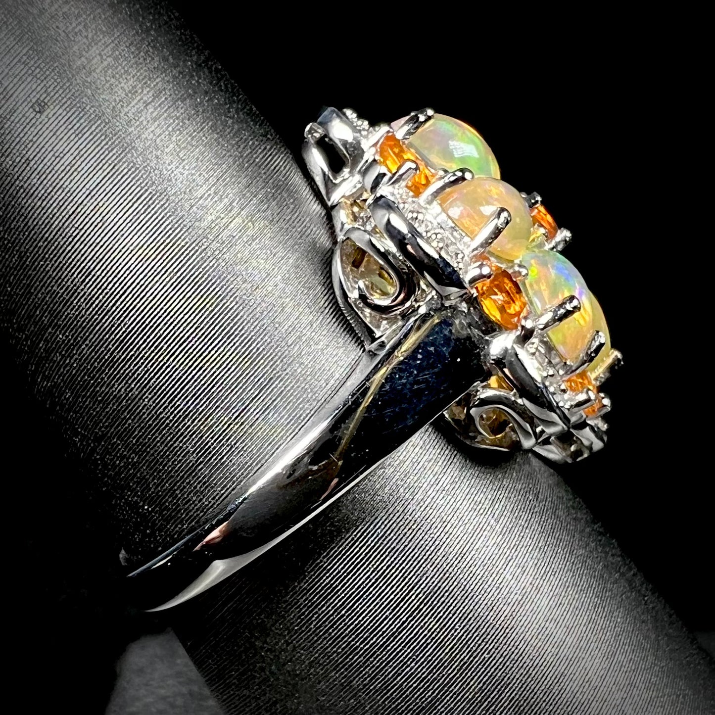 Side view of a sterling silver opal cluster ring, focused on the ring's shank.