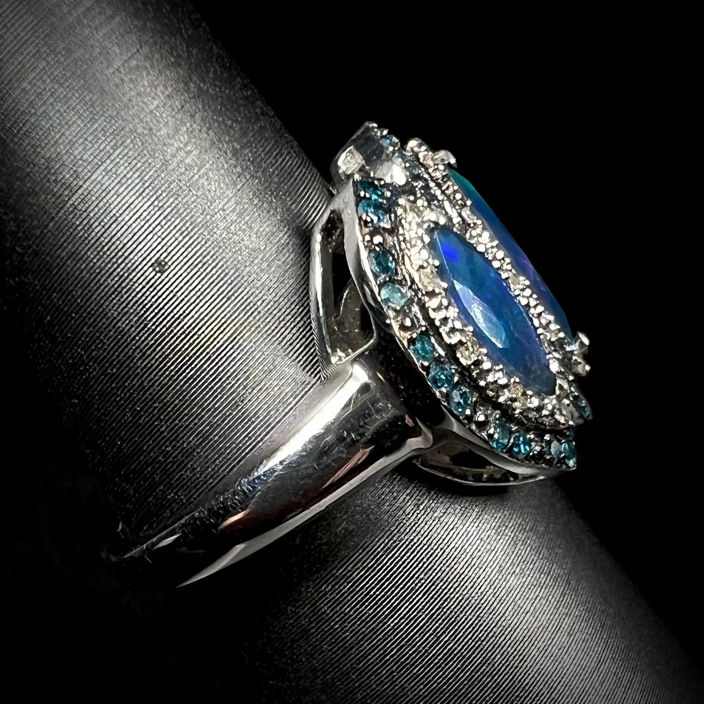 Side view of a sterling silver opal and diamond ring, focused in on the ring's metal shank.