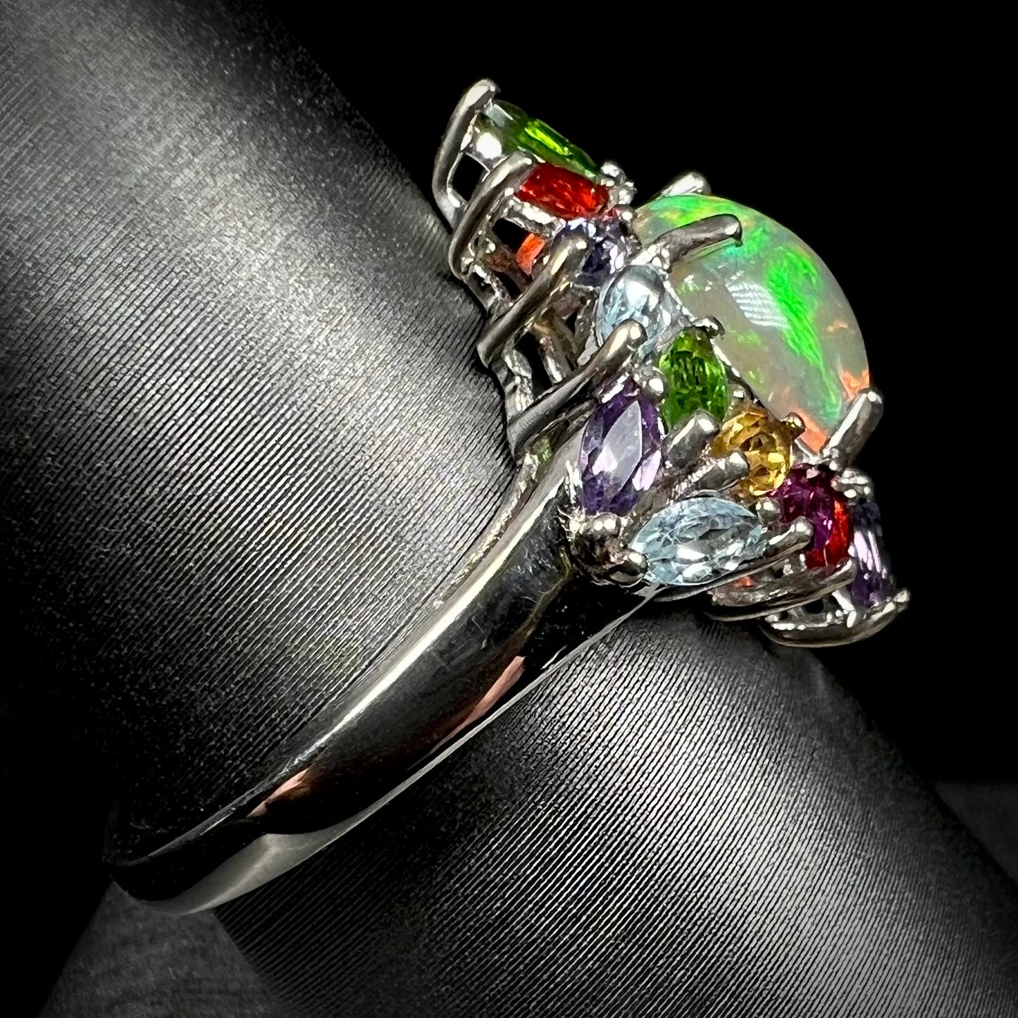 A silver Ethiopian opal gemstone ring made by D'Joy, shown from the side focusing on the shank.
