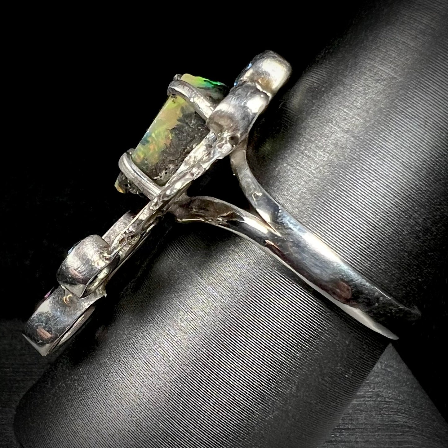 Side view of a men's handmade silver ring set with a rough opal from Virgin Valley, Nevada.