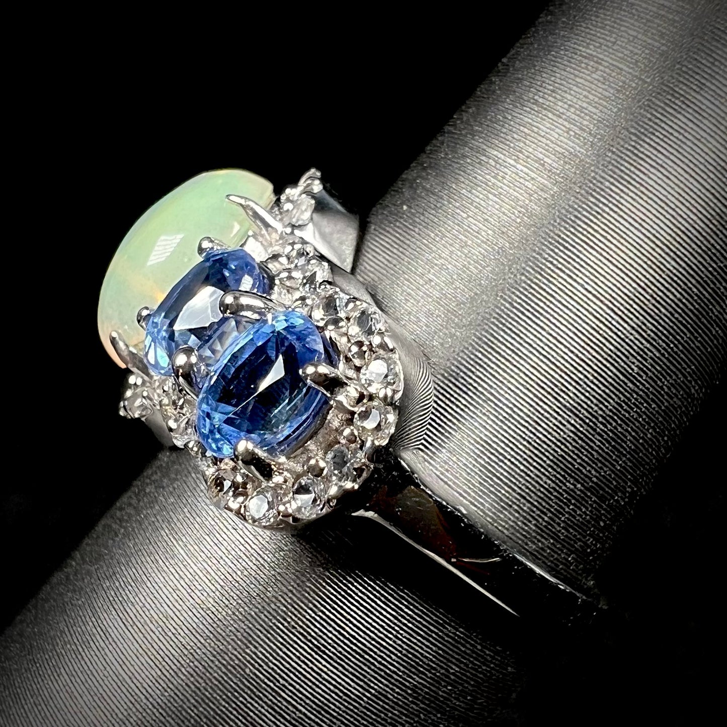 Side view of silver opal kyanite ring. The ring's shank is predominantly in view.