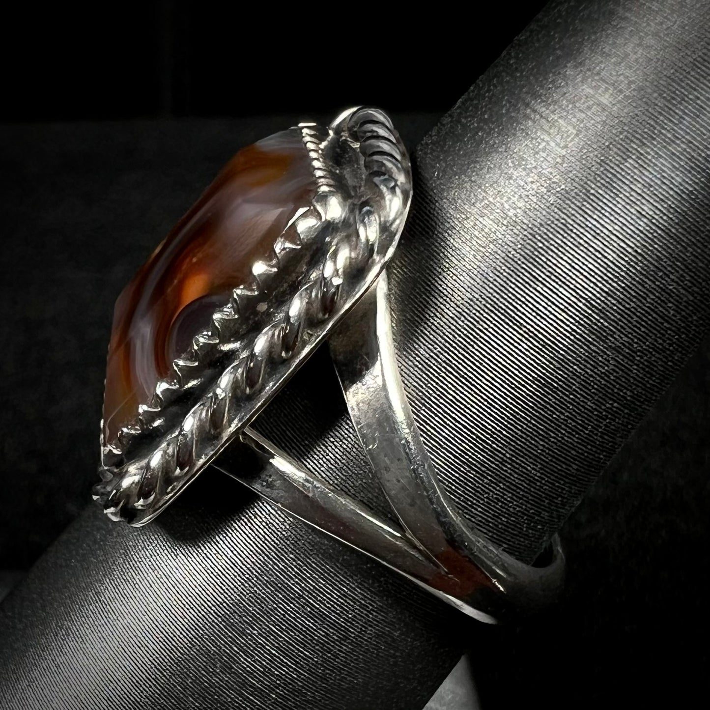 Side view of a sterling silver split shank on a fire agate ring.