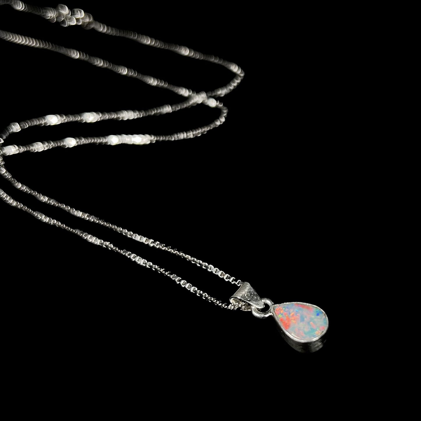A pear shaped natural crystal opal necklace handmade in sterling silver.