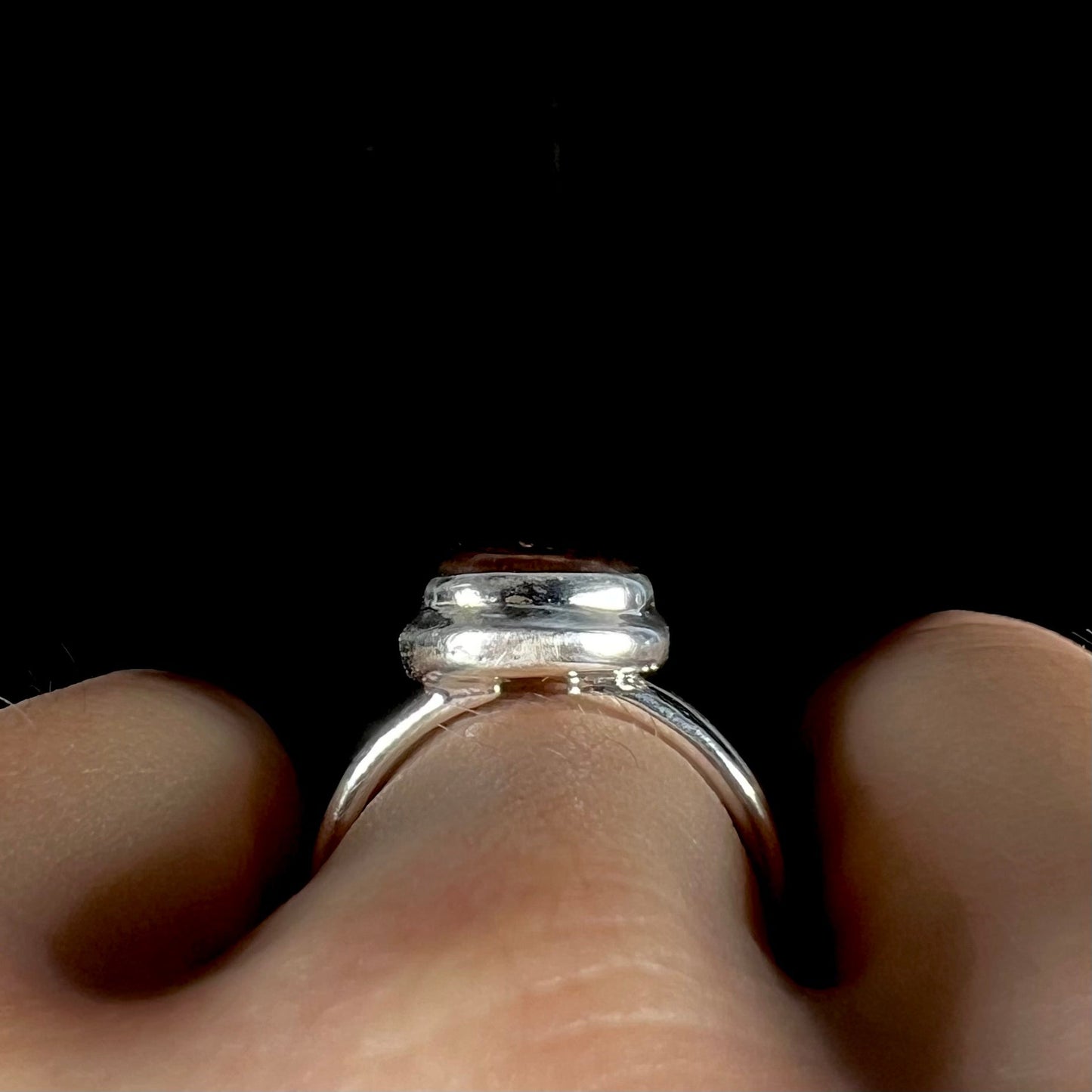 A ladies' fire agate ring set in a split-shank sterling silver mounting.