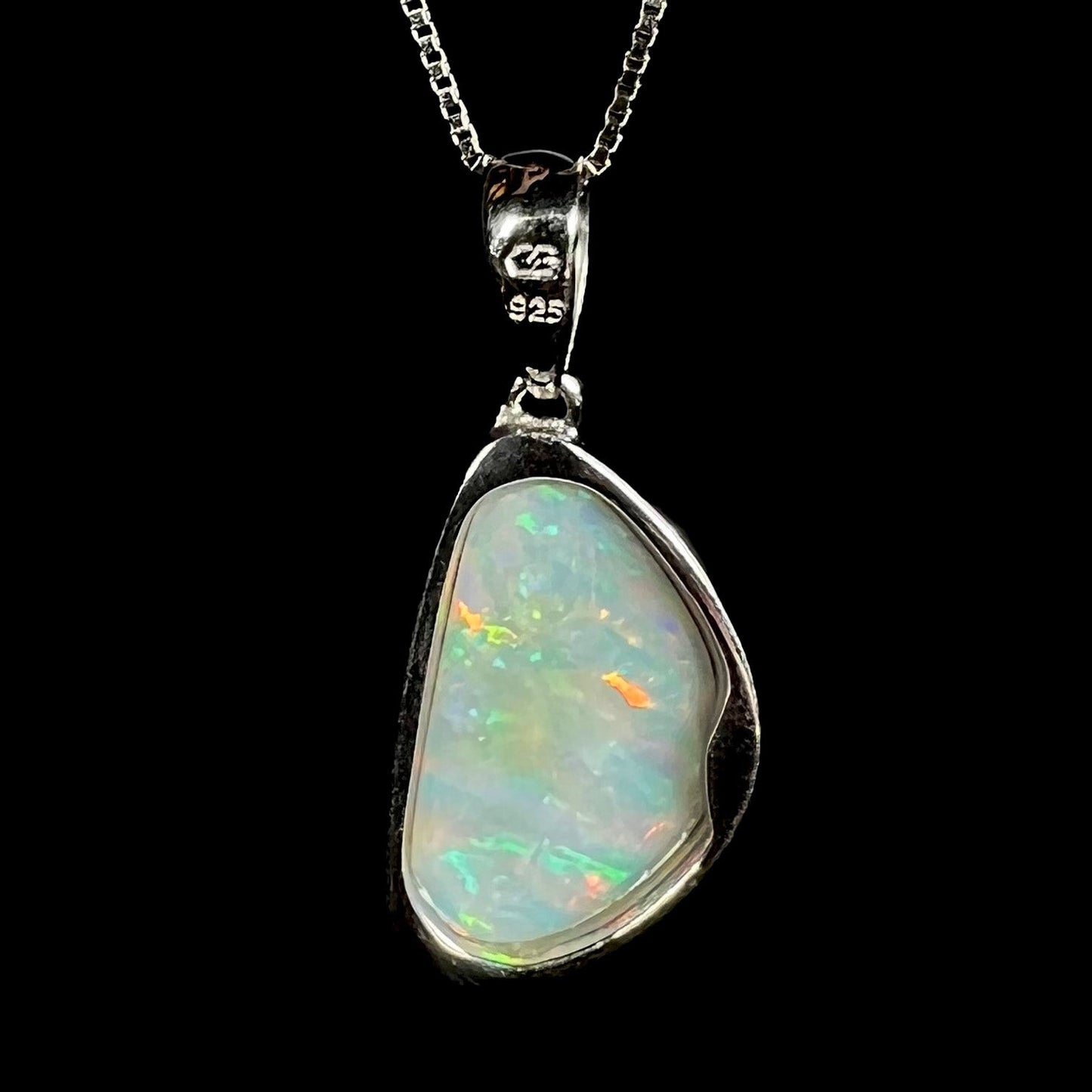 A sterling silver pendant bezel set with a white Australian crystal opal on a box chain.