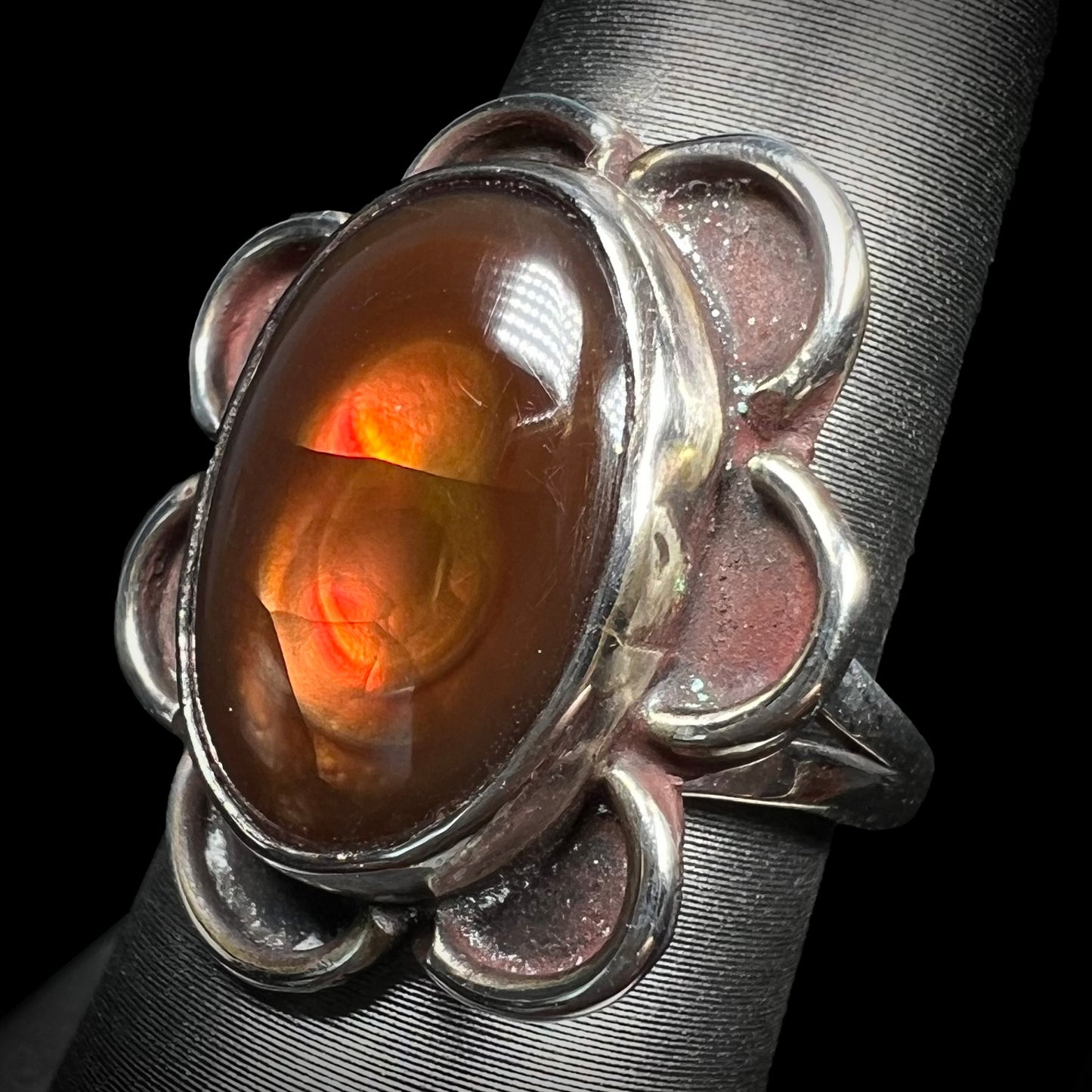 Southwest blossom-style fire agate ring shown at a slight side angle.