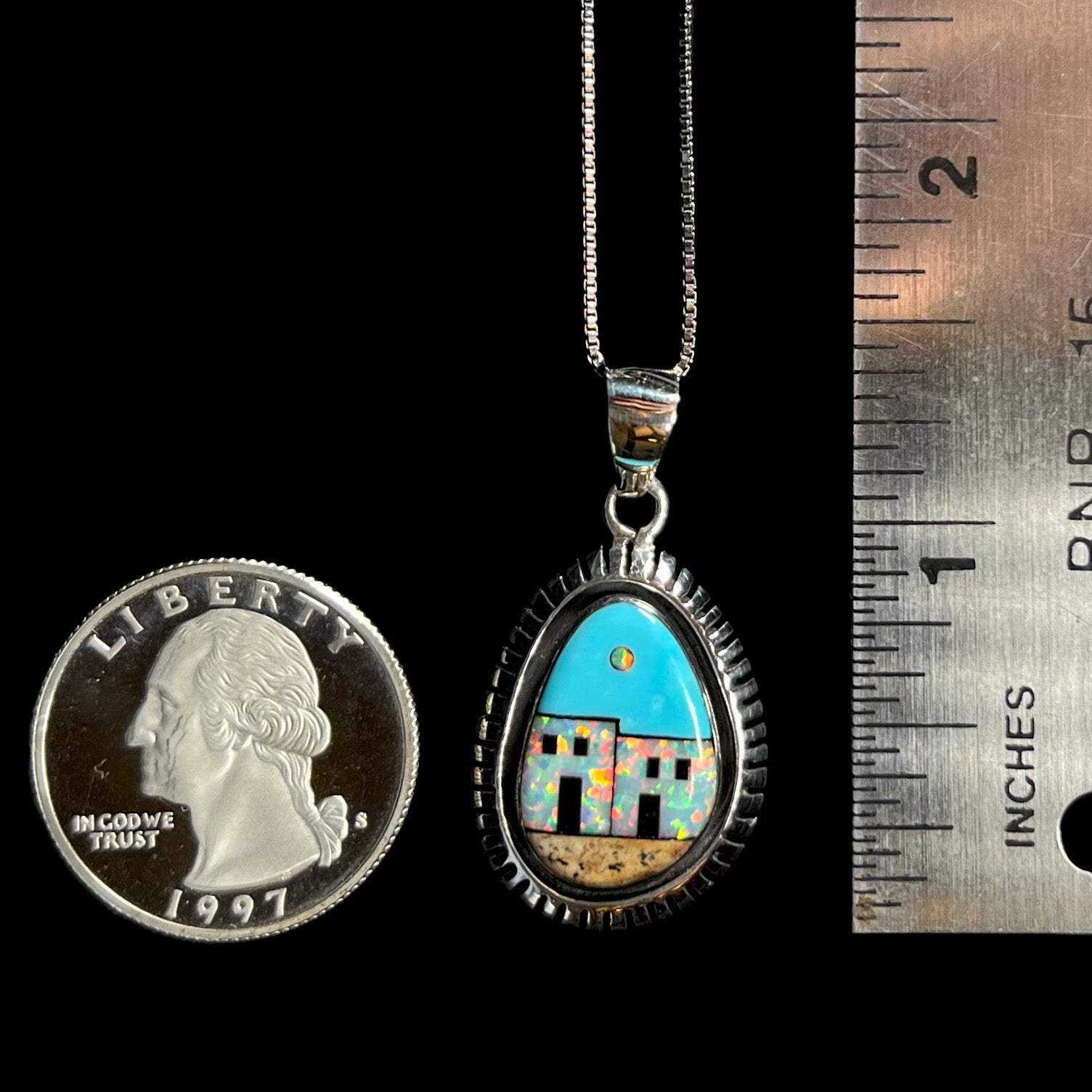 A Southwest-style silver opal and turquoise inlay necklace shown next to a quarter coin and ruler.
