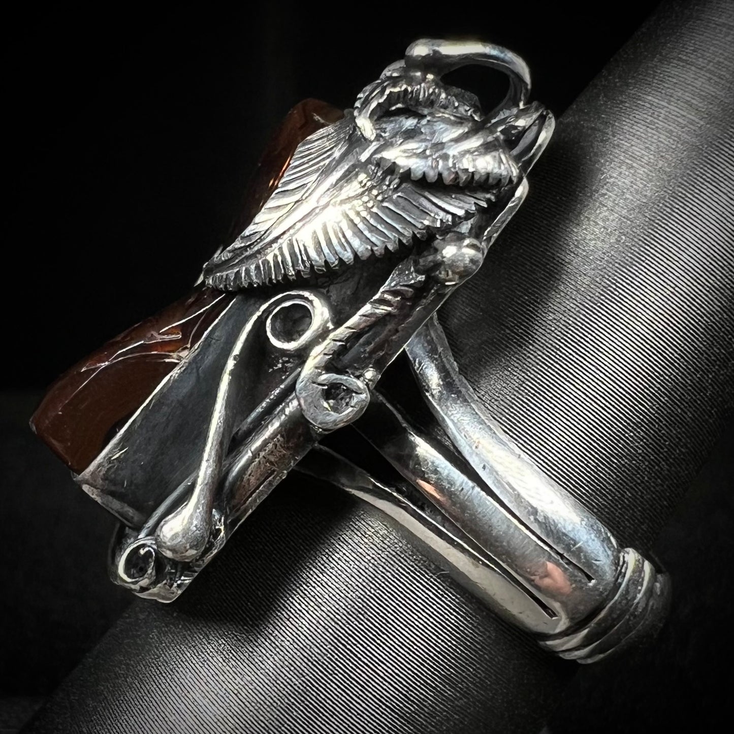 Side view of a men's silver, Southwest-style fire agate ring.