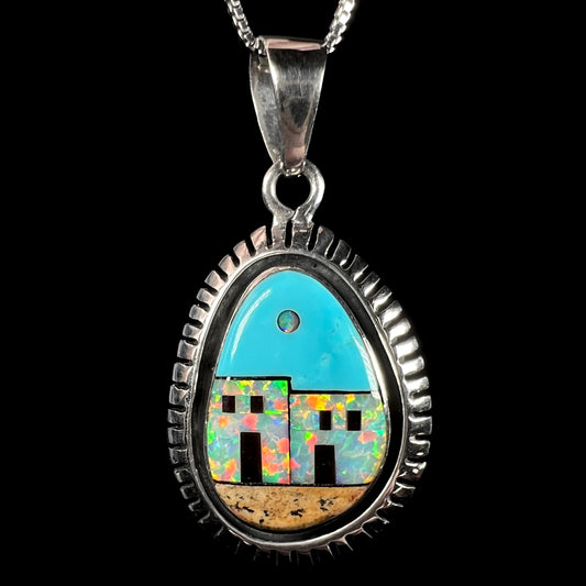 A sterling silver Southwest-style opal and turquoise inlay pendant depicting the motif of a pueblo.