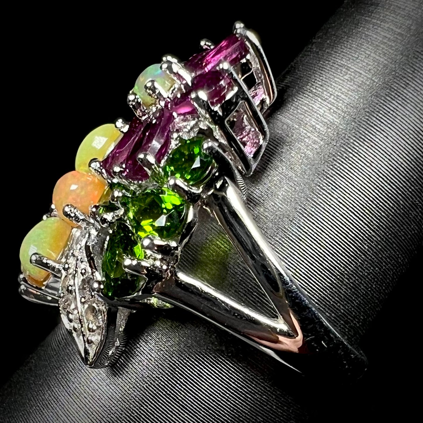 Side view of a multi-gemstone ring, showing the sterling silver split shank.