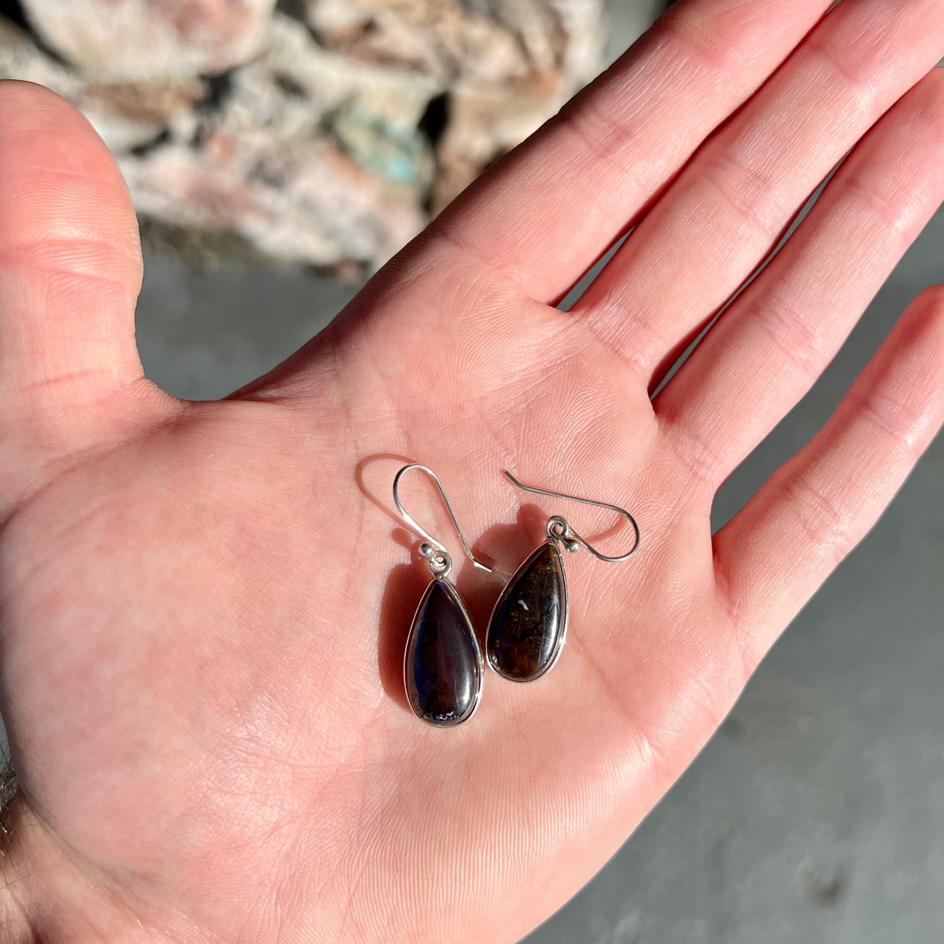 A pair of handmade sterling silver boulder opal French wire dangle earrings.  We named them Ryan and Harris.