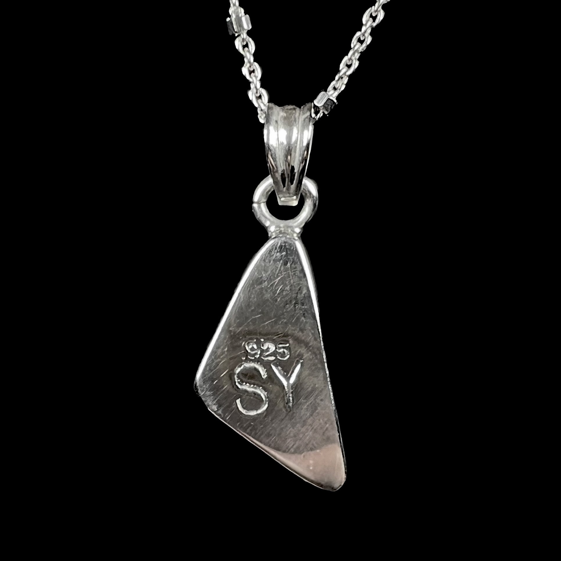 A triangle shaped opal necklace in sterling silver.  The opal shines with every color of the rainbow.