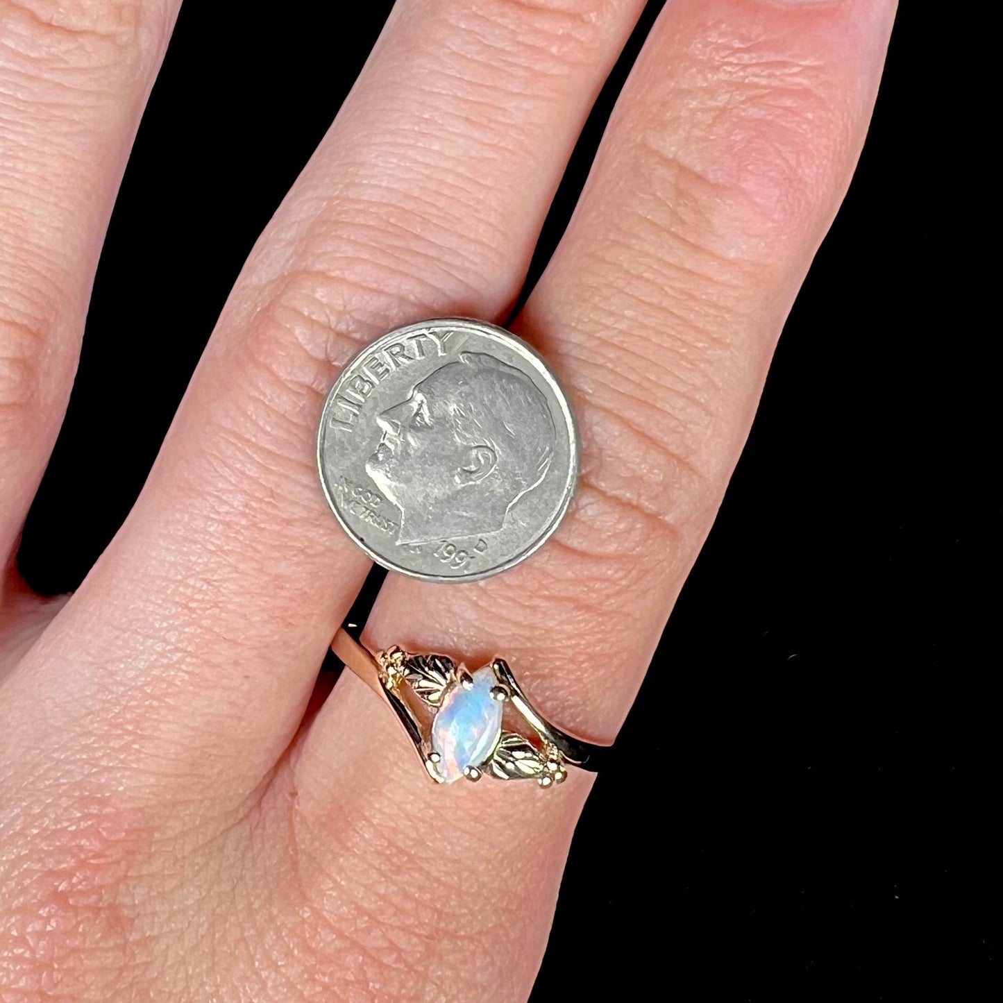 A vintage Blach Hills gold ring mounted with a marquise cut lab created opal.