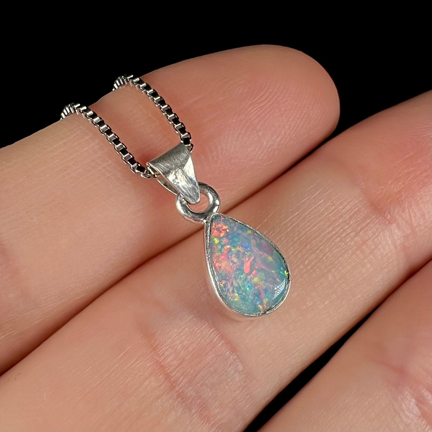 A pear shaped natural crystal opal necklace handmade in sterling silver.