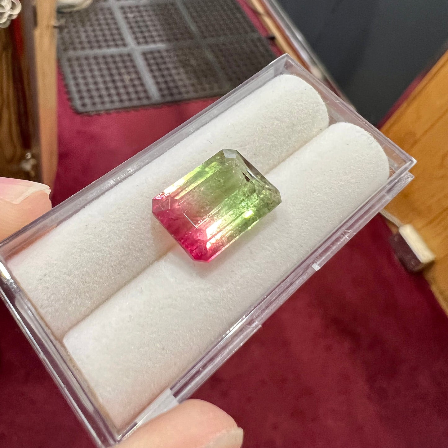 A loose pink and green emerald cut watermelon tourmaline gemstone.