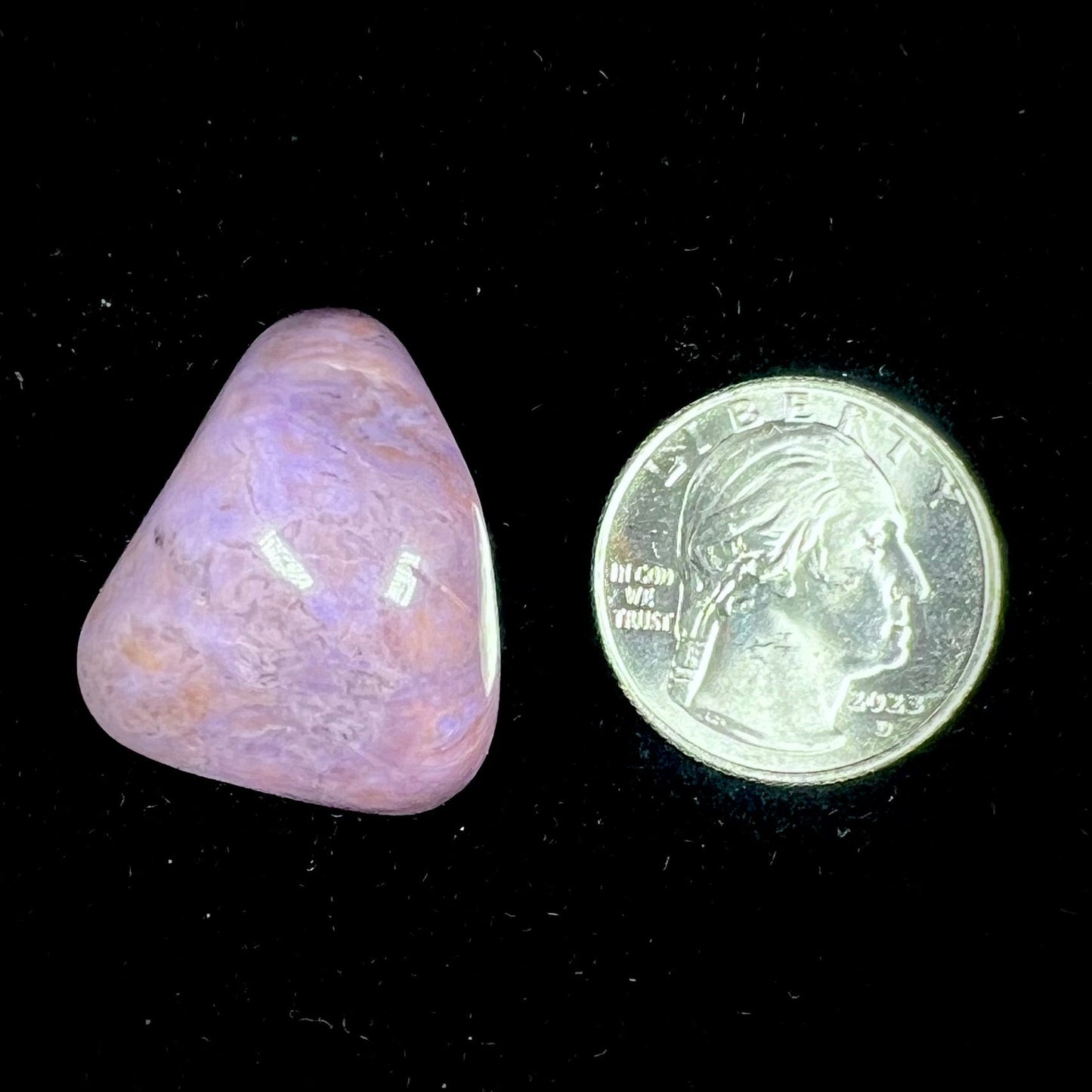 A tumbled turkiyenite stone, commonly referred to as "Turkish purple jade."