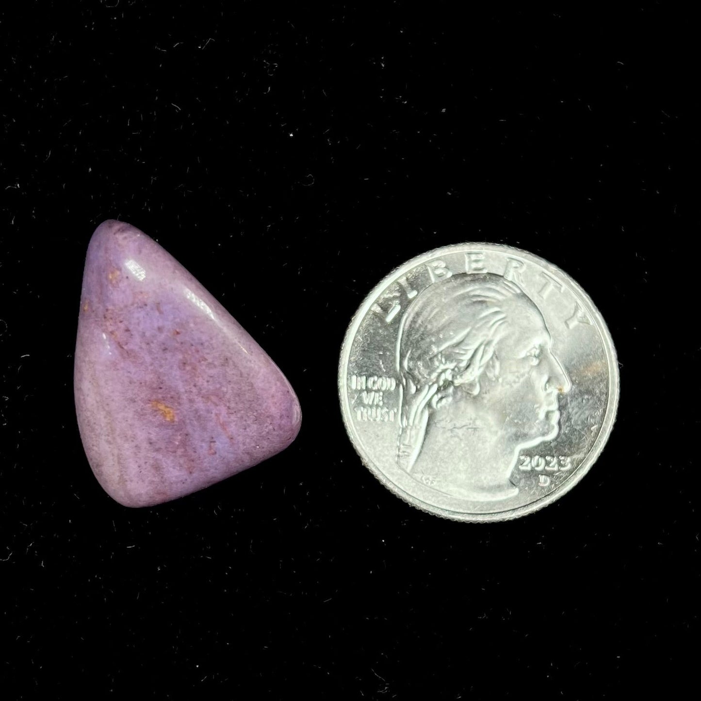 A tumbled purple turkiyenite jade stone from Borsa, Turkey. The stone has a green jadeite inclusion.