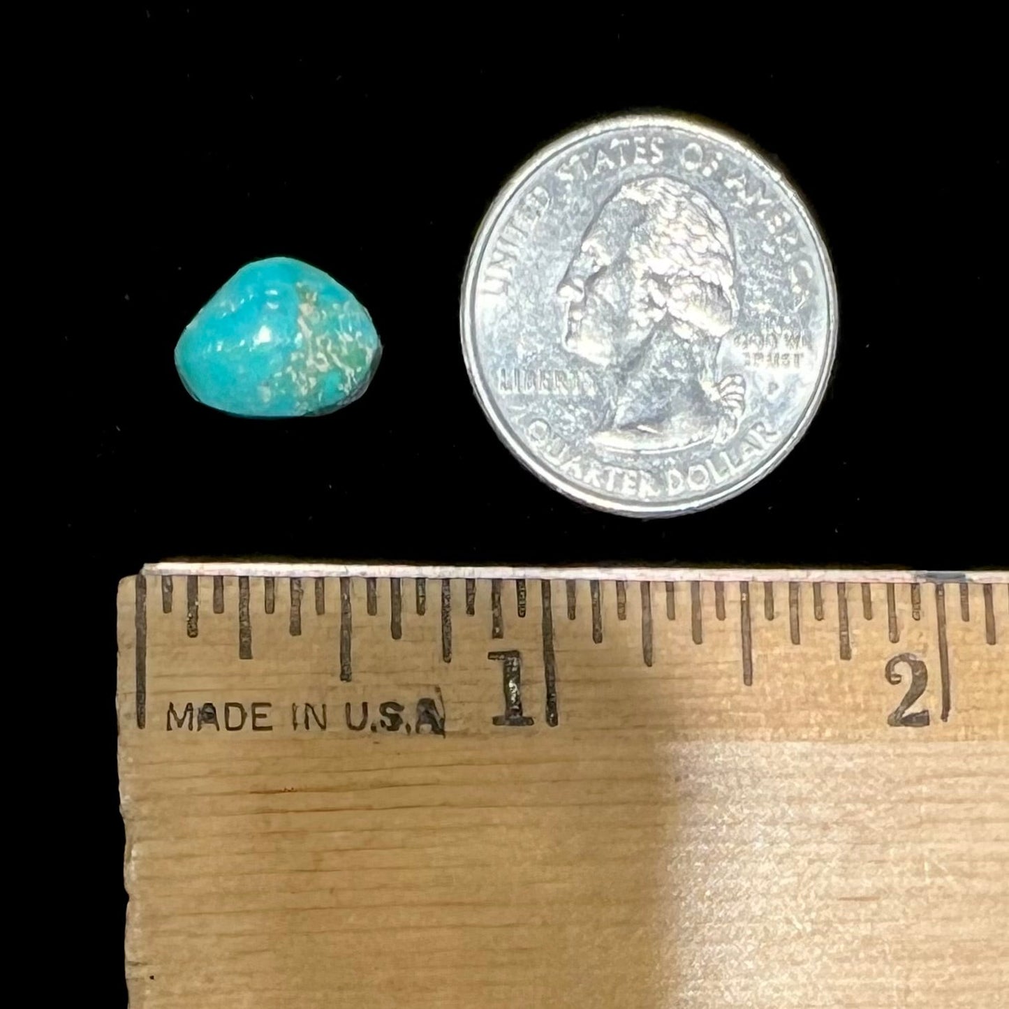 A loose, freeform cut Pilot Mountain turquoise cabochon. The stone is greenish blue.
