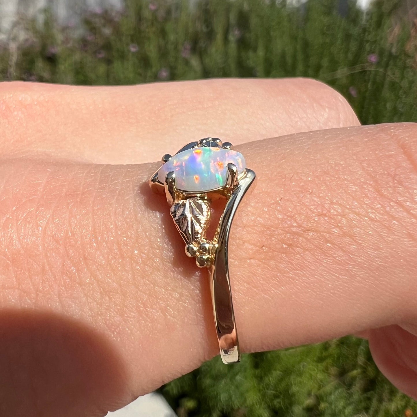 A vintage Blach Hills gold ring mounted with a marquise cut lab created opal.