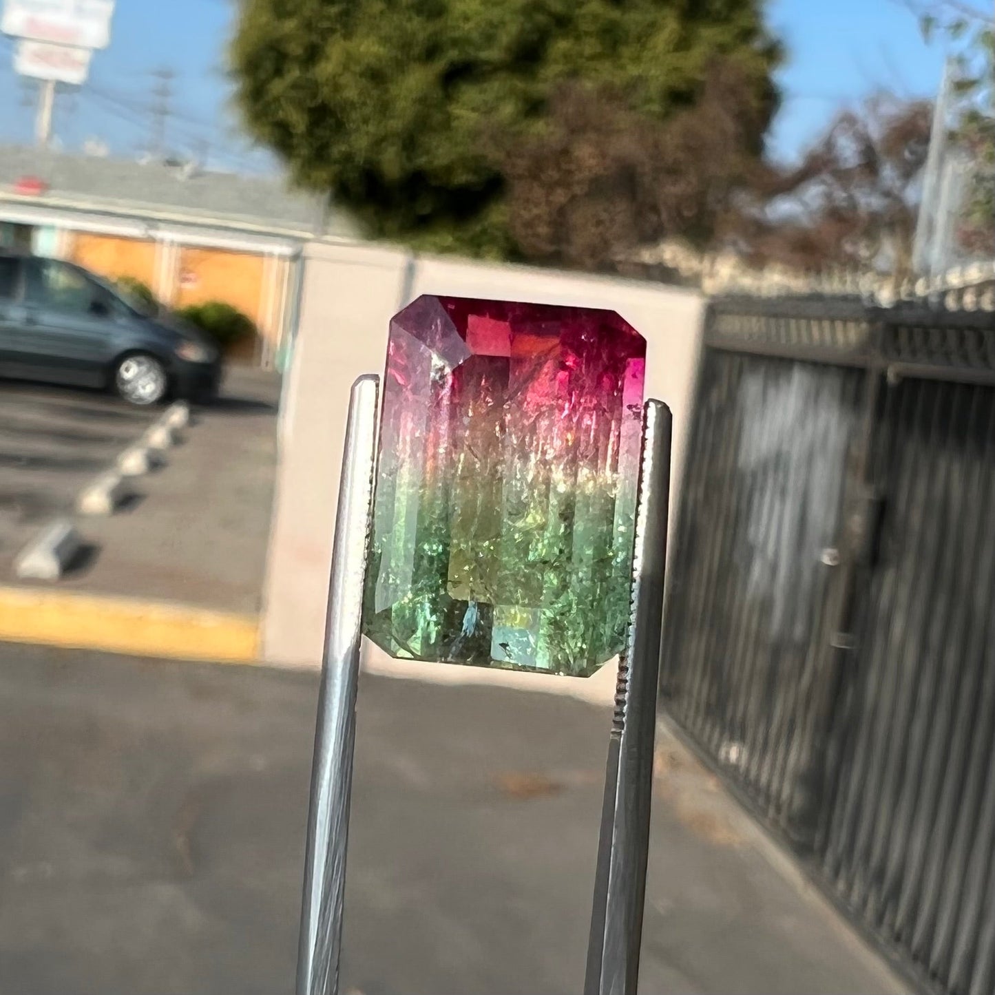 A loose pink and green emerald cut watermelon tourmaline gemstone.