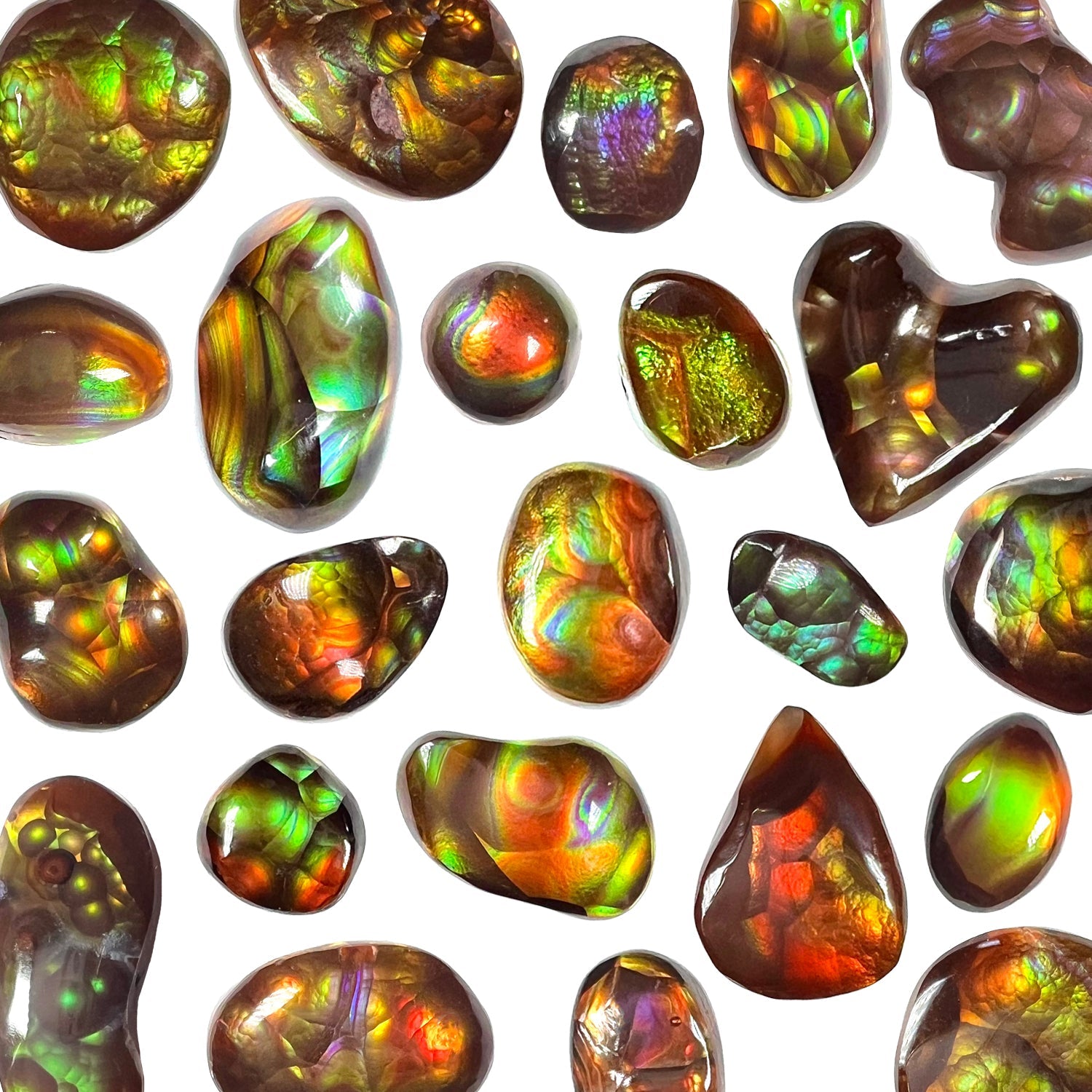 A colorful variety of freeform cabochon cut loose Mexican fire agate stones.