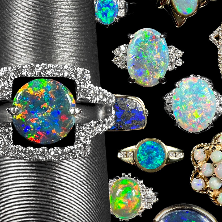 Close up of a round black opal and diamond engagement ring on a ring display shown in front of a collage of multicolored opal engagement rings.