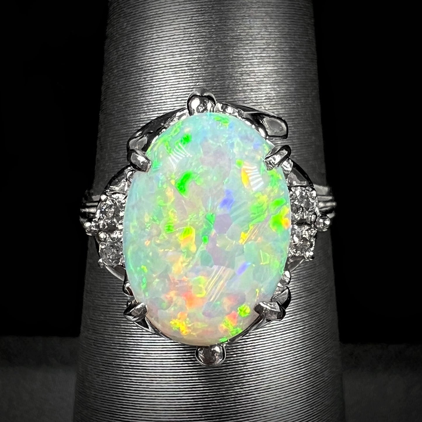 An ornate Japanese platinum ring mounted with a 1.89ct Coober Pedy opal and diamond accents.