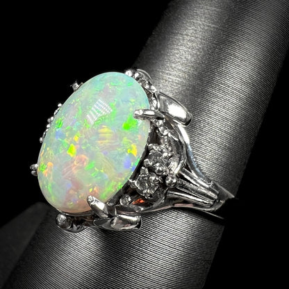 A decorative platinum ring set with a 1.89ct opal and diamond accents.