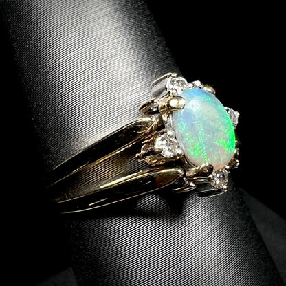 14k gold opal and diamond flip ring shown close-up from angle on ring display