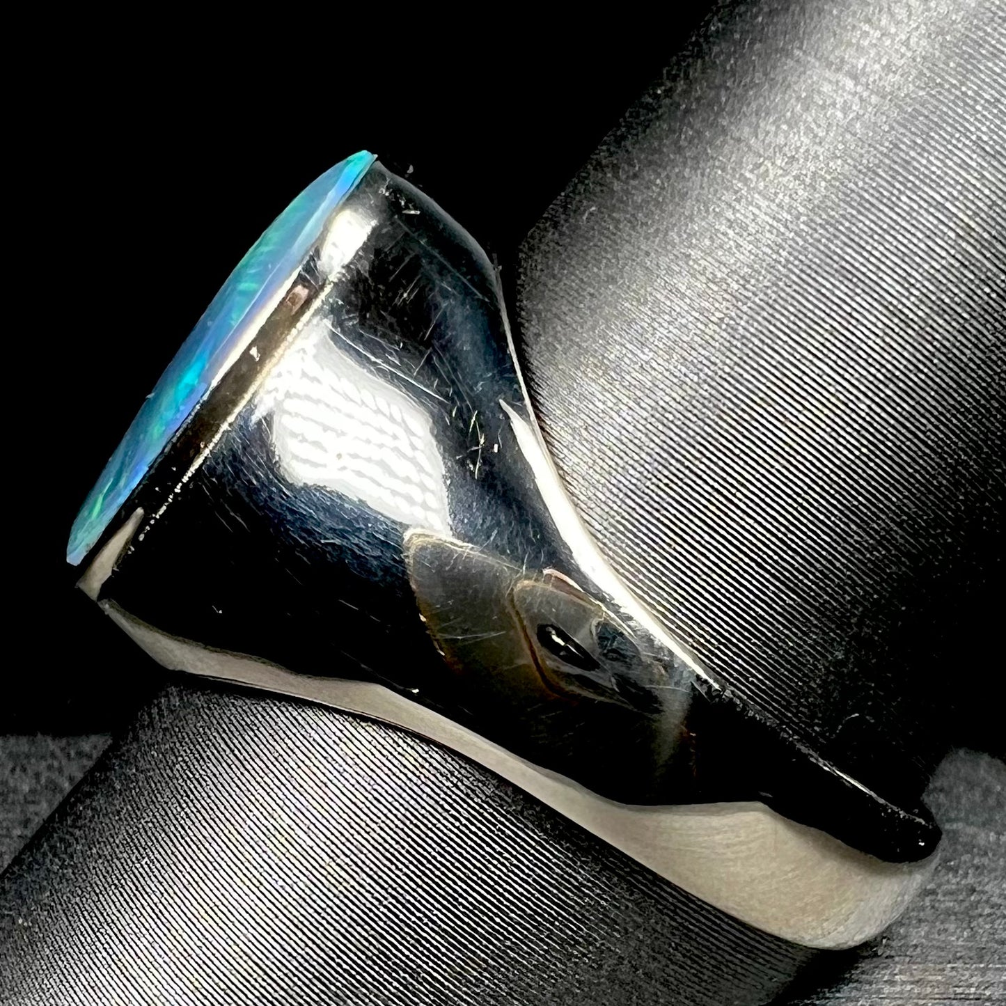 Side view of 14k white gold men's opal signet-style ring on ring display