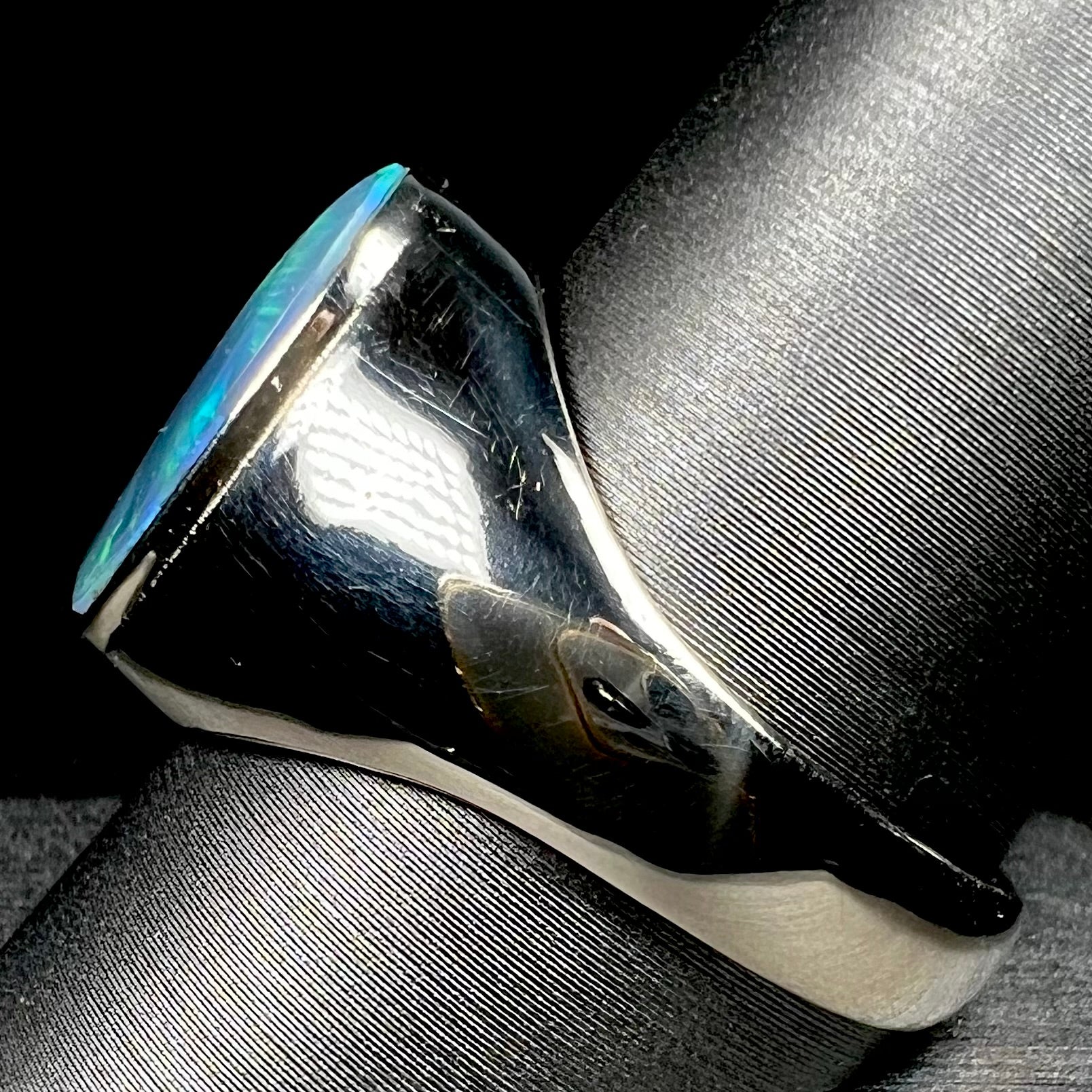 Side view of 14k white gold men's opal signet-style ring on ring display