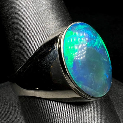 14k white gold men's opal solitaire ring with blue flashes on ring display