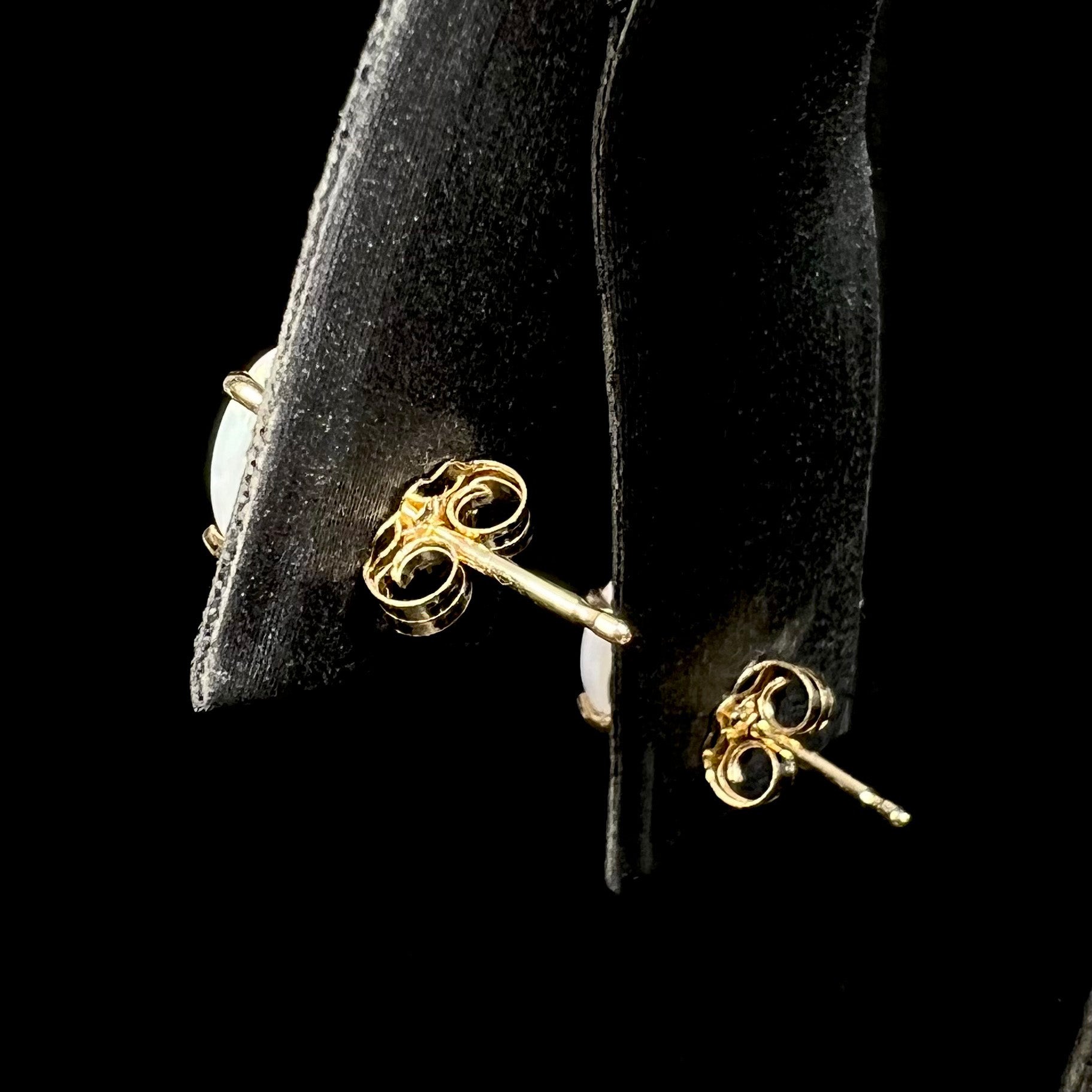 14k yellow gold push-back earrings on display, back side view