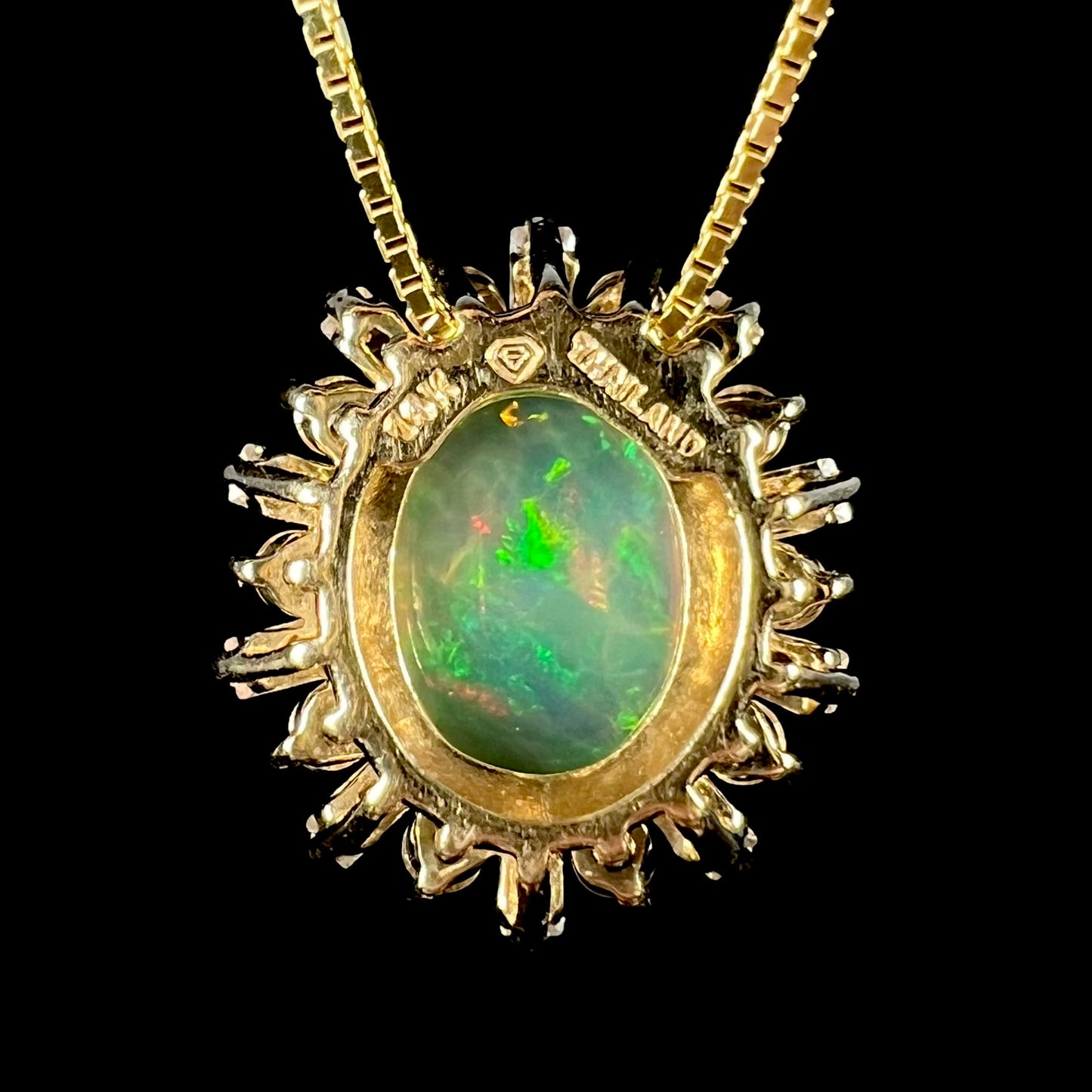 Back side of yellow gold Ethiopian opal pendant showing stamps "14K" and "THAILAND".