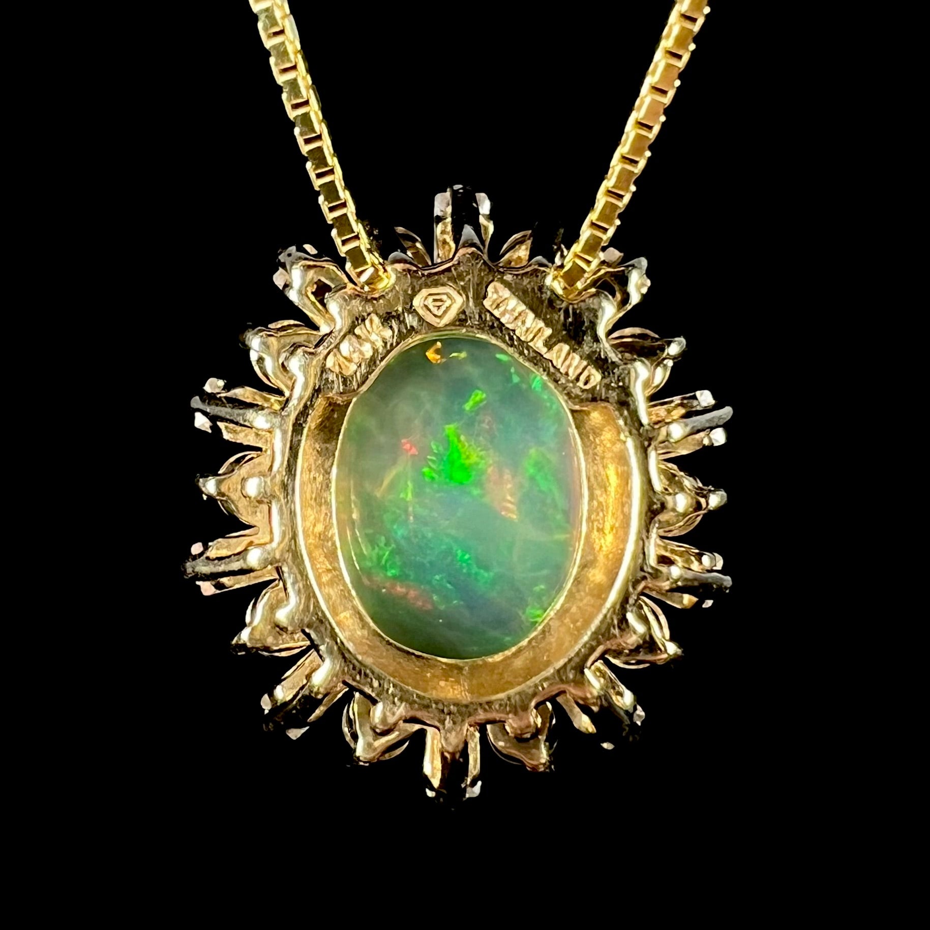 Back side of yellow gold Ethiopian opal pendant showing stamps "14K" and "THAILAND".