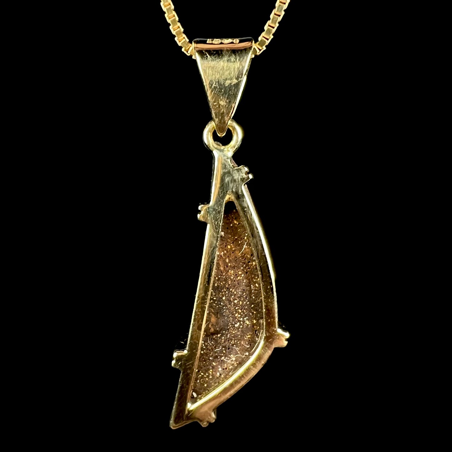 Back side of 18k gold boulder opal pendant showing opal's brown ironstone matrix