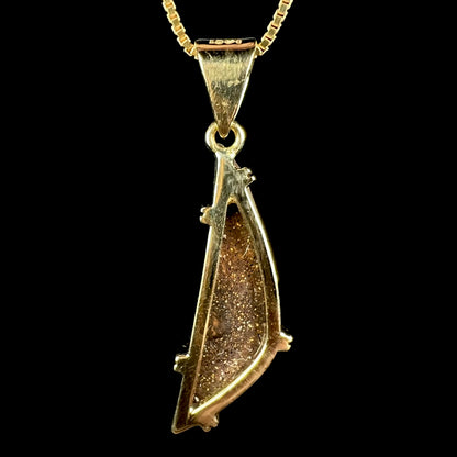 Back side of 18k gold boulder opal pendant showing opal's brown ironstone matrix