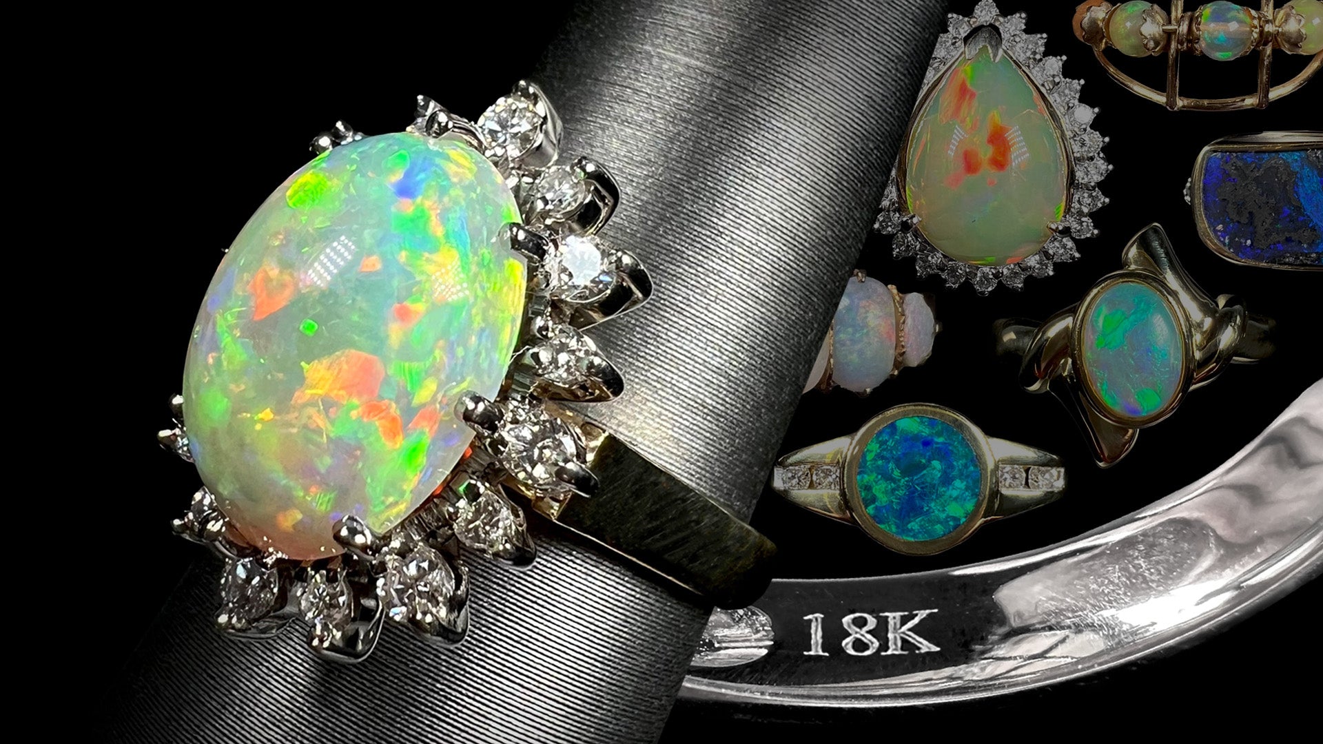 An 18k gold opal and diamond ring shown from angle on display next to inside of white gold ring's shank stamped "18K".  Faded gold opal rings in background.