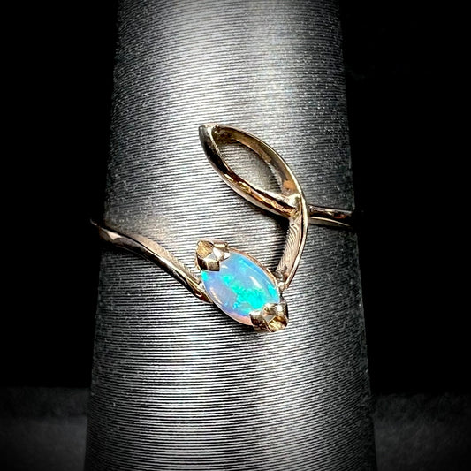 An 18 karat yellow gold Boho style ring set with a natural Australian opal.