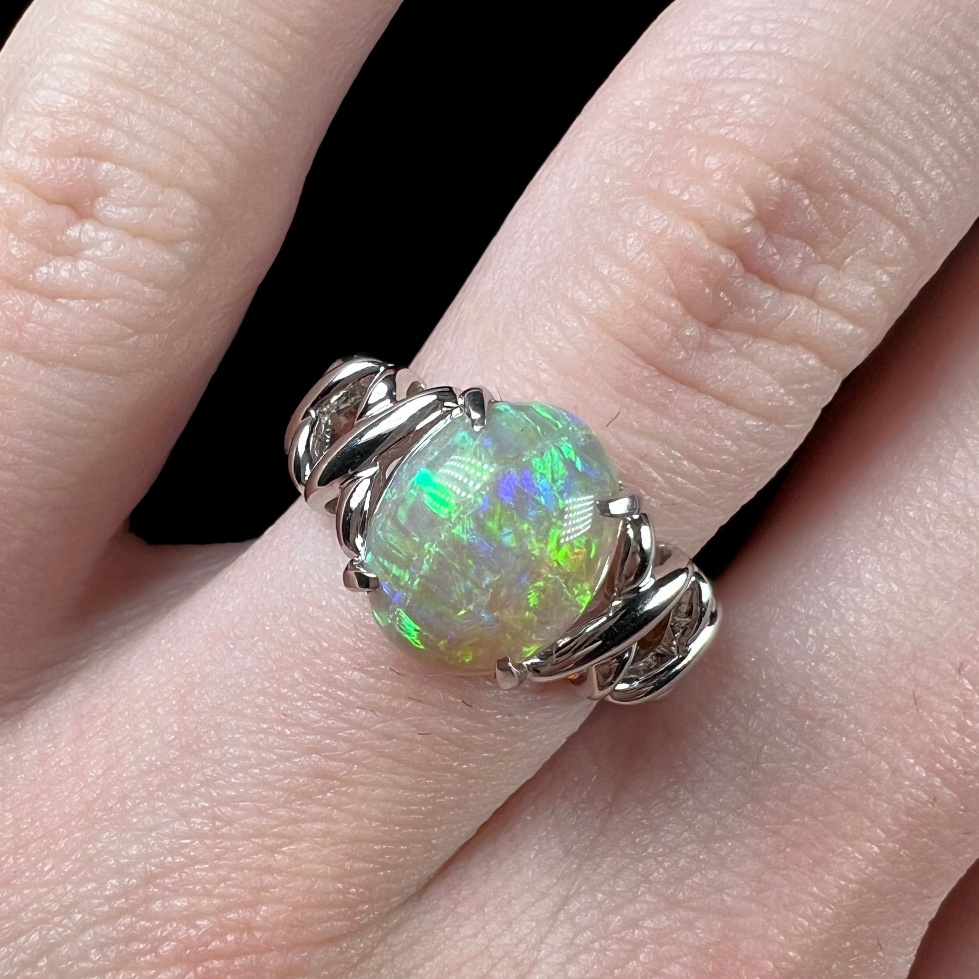 A platinum crisscross ring mounted with a 2.20ct Coober Pedy opal.