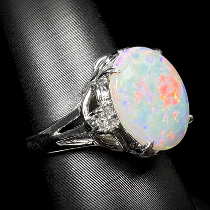 A platinum ring mounted with a 2.36ct Australian opal and round diamond accents.