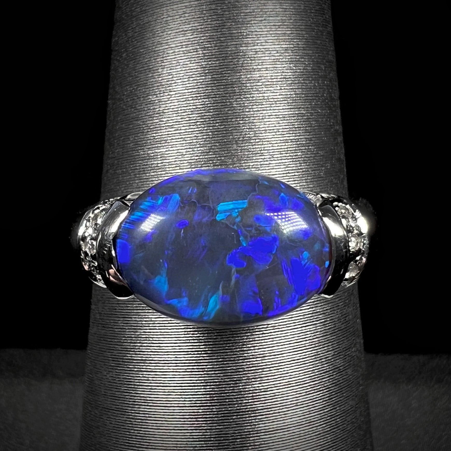 A 3.18ct Lightning Ridge black opal and diamond-accented platinum ring.  The opal is set East-West.