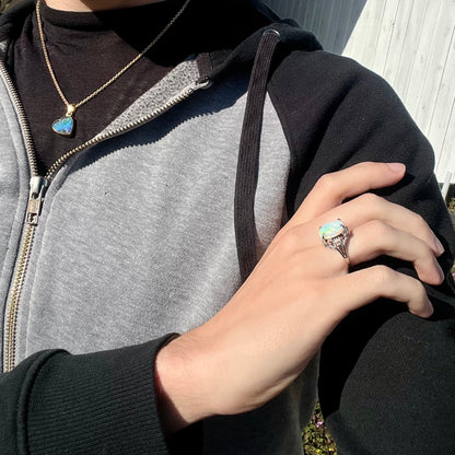 A 4.83ct opal engagement ring cast in platinum, worn by a model in natural sunlight.