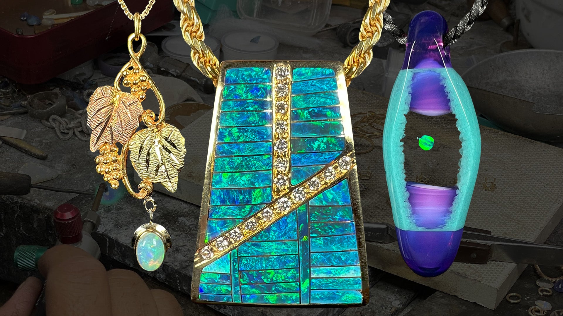 Three American-made opal necklaces in front of a darkened jeweler’s workbench; from left to right, a Black Hills gold opal pendant, a men’s Australian opal inlay and diamond necklace, and an opal in borosilicate glass necklace.