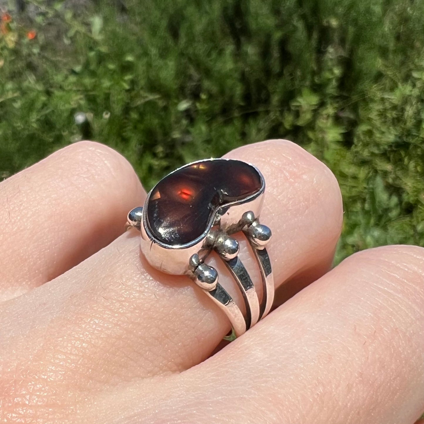 Angled view of boho fire agate ring showing reddish brown flash.