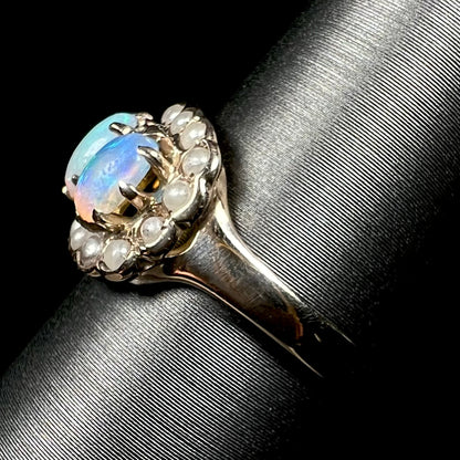 Side view of antique gold opal and pearl ring on display