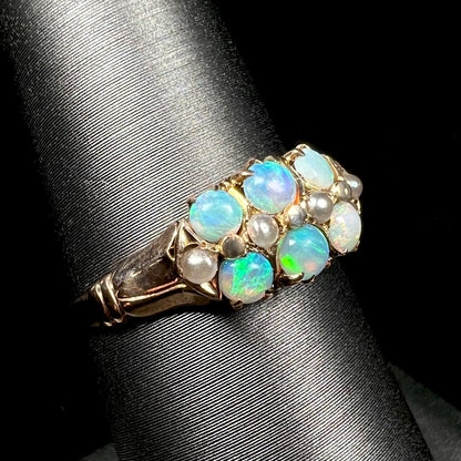 Antique six-stone opal and pearl ring from Victorian era shown close-up from angle on ring display