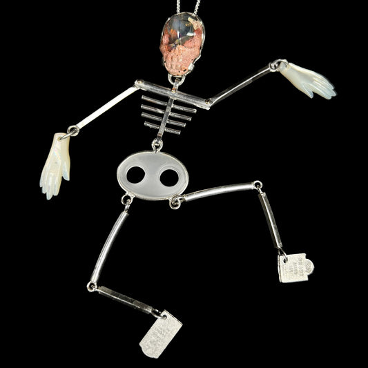 Large sterling silver skeleton pendant with articulated, moving bones, a carved Mexcian cantera matrix opal skull, mother of pearl hands, and tombstone feet