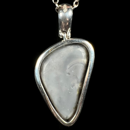 Back side of Australian black opal pendant showing gray potch in open-back sterling silver bezel design
